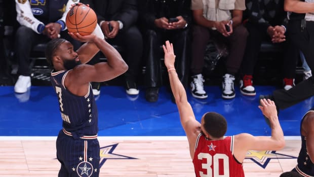 Jaylen Brown shoots over Stephen Curry